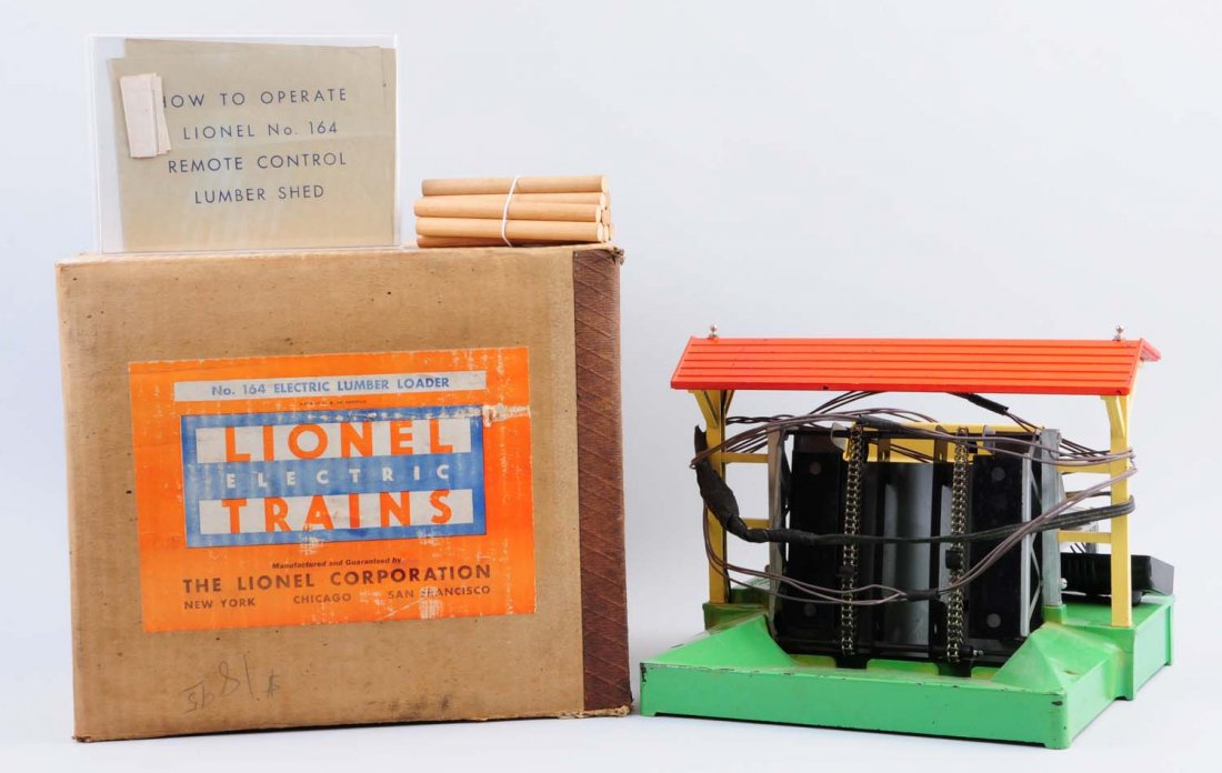 Lionel 165 Lumbar Loader OB.: 164 Lumbar loader is complete and all original. Has some scratches and paint chips throughout mainly on roof and base. Has instruction sheets with original box that has no liner. Condition (Good).