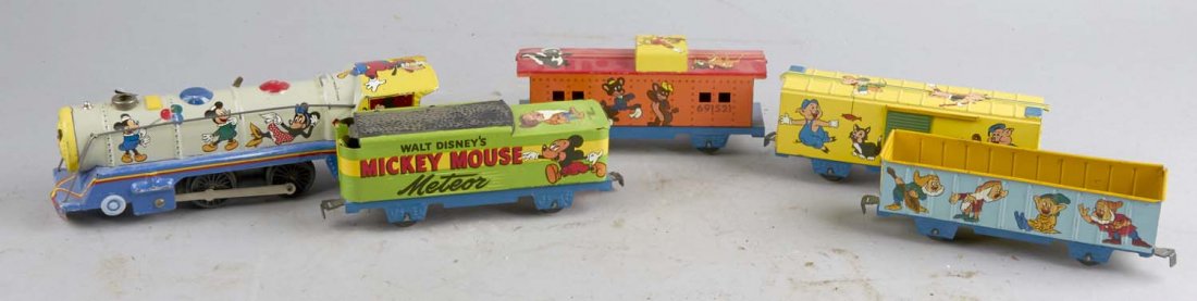 Marx Walt Disney's Mickey Mouse Meteor Train Set: 5 piece tin litho set #691521. Includes 1 engine, 1 caboose and 3 cars featuring Mickey, Minnie, Goofy, characters from Bambi, Snow White, Dumbo, Pinocchio and others. Condition (Very good). Size 7-1/
