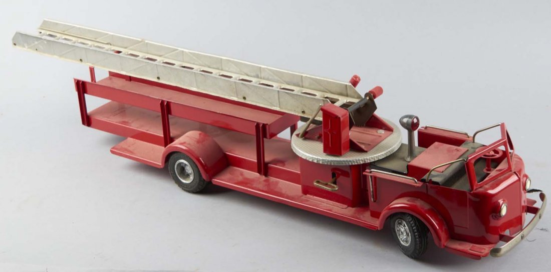 Ladder Truck Wind-Up Toy: Red and black with working steering wheels. Condition (Excellent). Size 28" L.