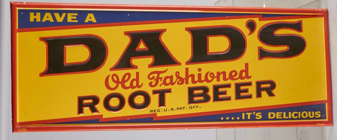 Dad's Root Beer Tin Sign: Self-framed, single-sided sign reads, "Have a Dad's old fashioned root beer...it's delicious." New old stock. Marked PM-5. Condition (Near Mint). Size 46-1/2" x 17-1/2"