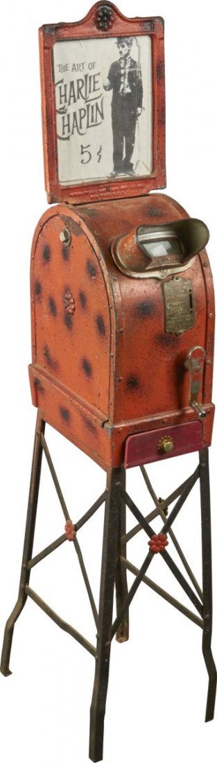 5¢ The Art Of Charlie Chaplin Mutoscope: Metal cabinet has been painted orange with black sprayed regions. Made by The International Mutoscope Reel Co. New York. Both cabinet and base feature floral design. Condition (Fair). Size 52" x 14" x