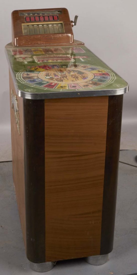 Token-Operated Buckley "Track Odds" Slot Machine: Horse race console gaming machine. Circa 1937. No. 460566. Has cracked clear glass on coin drop and is missing back panel. Includes key. Condition (Fair). Size 39-1/2'" x 18-1/2"