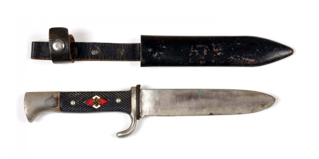 Nazi Hitler Youth.: Hitler youth knife with un-etched blade. Black checkered grips with plated iron mounts. Handle bears an enameled inlay of a swastika. Blade has been put on a grinding wheel, still bears a manufacturer