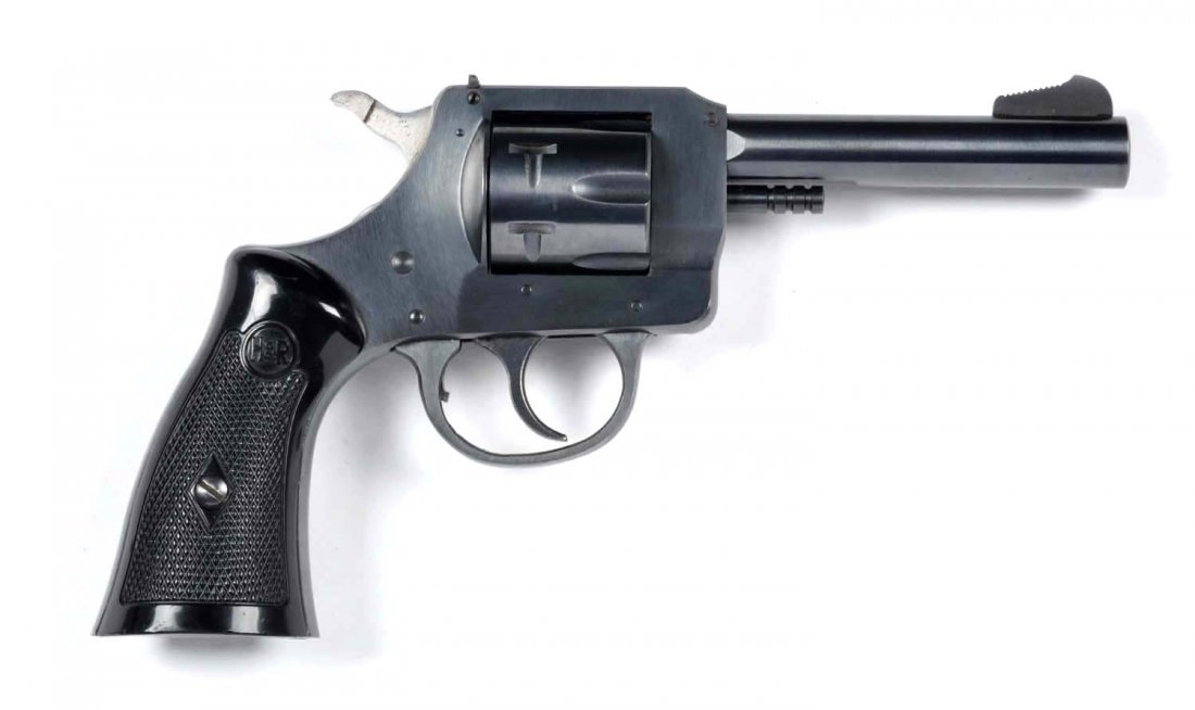 **Near New H&R Model 732 Revolver.: Serial # AH10731 High quality standard revolver features a 4" barrel, blued finish, doubled action, six shot, chambered for the .32 Smith & Wesson cartridge, with monogram plastic grips. Aside from a