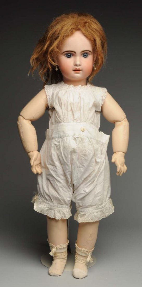 Beautiful Jumeau Bébé Doll.: Bisque socket head with red Tête Jumeau stamp (several black specks on forehead), long multistroked eyebrows, blue paperweight eyes, painted upper and lower lashes, open mouth with molded upper teeth