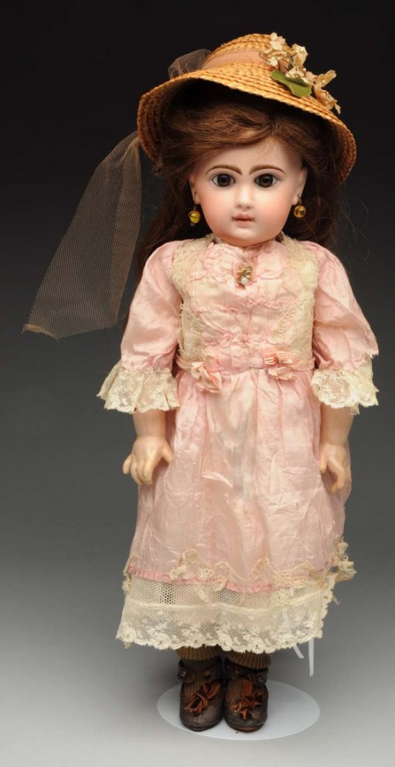 Pretty Jumeau Bébé Doll.: French bisque socket head with Jumeau scrub mark and checkmarks (firing line across bridge of nose, nose rub) with multistroked eyebrows, painted upper and lower lashes, gray paperweight eyes (may be 