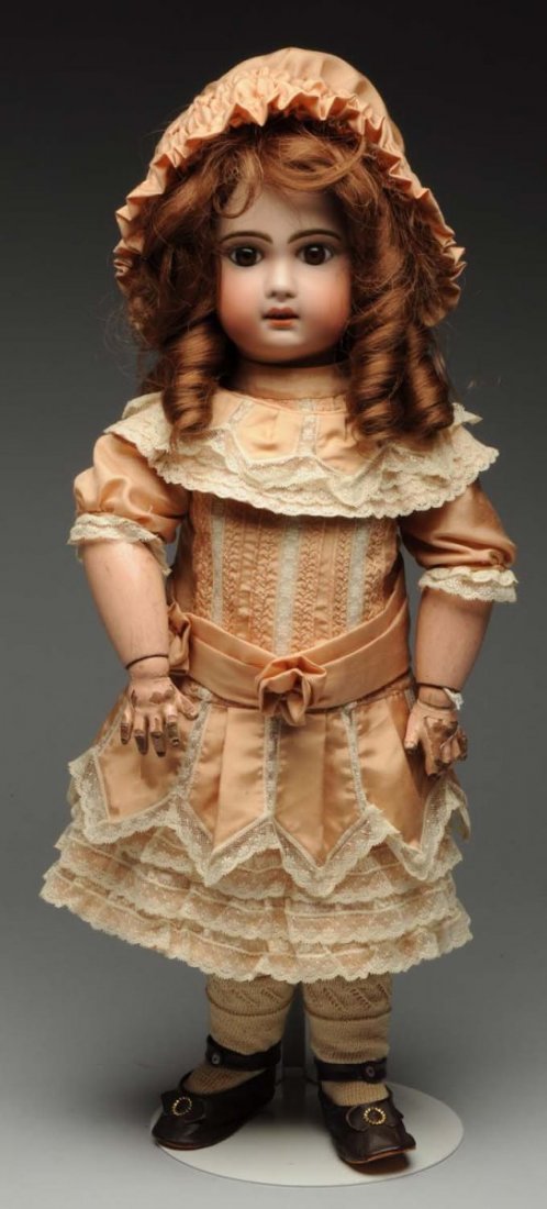Pretty Jumeau Bébé Doll.: French bisque socket head (extensive repair involving the right ear, but not the facial features), multistroked eyebrows, light brown paperweight eyes, painted upper and lower lashes (irregular cut on