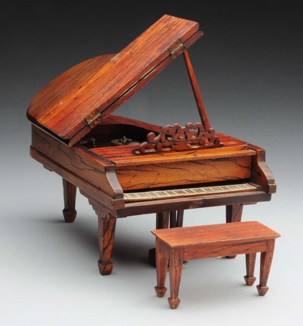TynieToy Grand Piano With Working Music Box.: Also includes a matching bench. 1920's - 40's and marked bench. Rare, hard to find piece, lid opens to reveal music stanard displays beautifully. Condition (Excellent). Size Tallest: 3 - 1/2".
