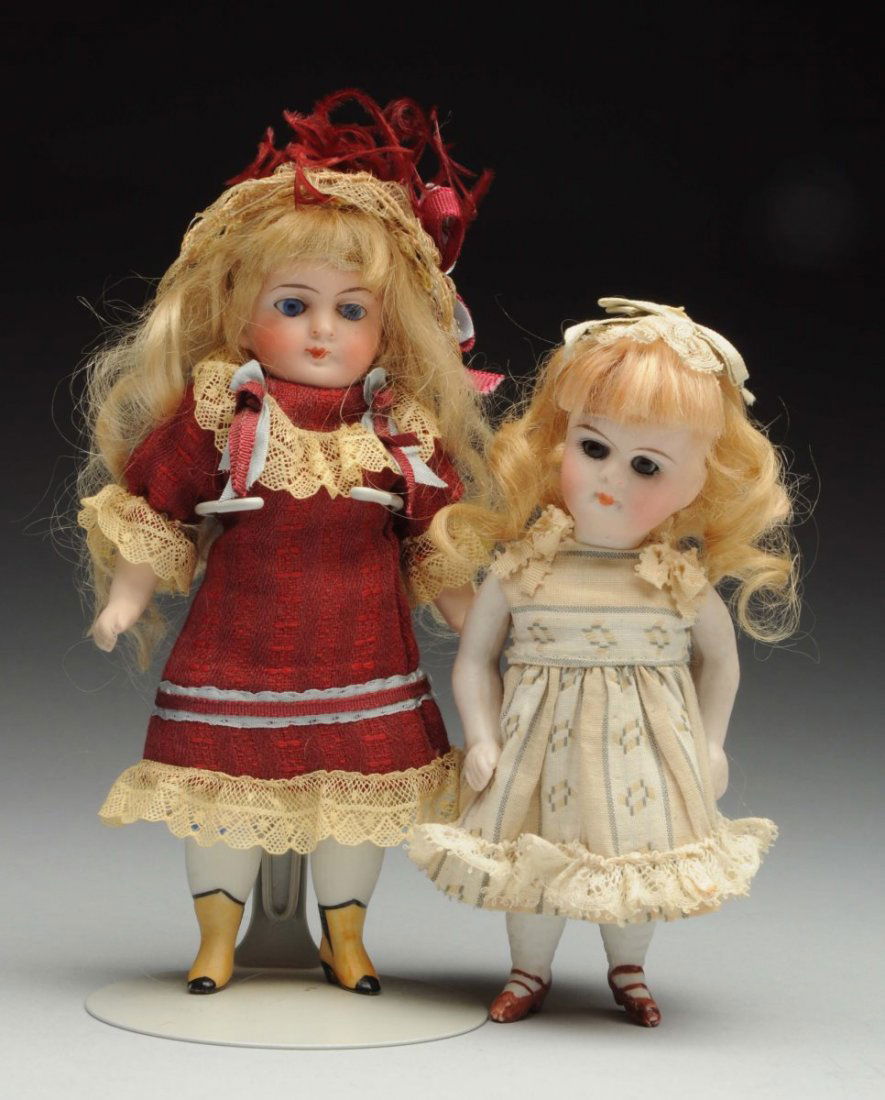 Lot Of 2: German All-Bisque Dolls.: One possibly by ABG with stationary glass eyes, tapered eyebrows, original mohair wig, stiff neck, pegged shoulders and hips, yellow boots with black toes, heels and insets. Kestner 208 with swivel ne