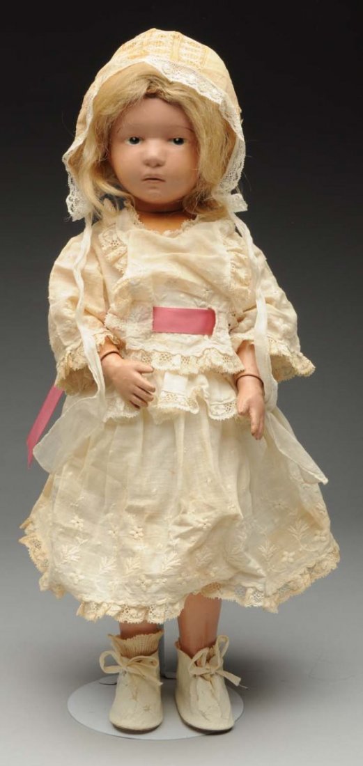 Pouty Schoenhut Character Doll.: All wood doll with metal spring joints and Schoenhut label, pouty face with intaglio eyes, closed mouth, original mohair wig (sparse in back) original face paint but some chips and fading; antique dre