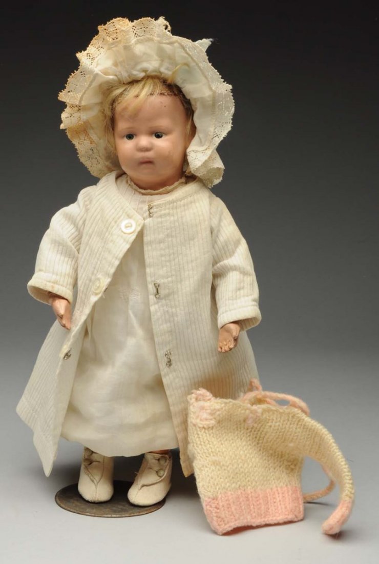 Petite Schoenhut Toddler Doll.: All wood spring jointed, original face paint (a few scuffs), original mohair wig (needs styling); antique dress, slip and coat, also hat and sweater included; original Schoenhut boots with holes in so