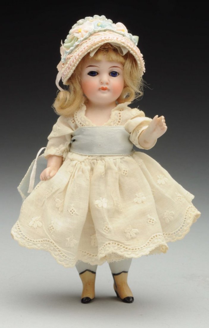 Sweet All-Bisque Doll.: German, possibly by Alt, Beck & Gottschalck with tapered eyebrows, cobalt blue glass eyes, closed mouth, chubby cheeks, lovely smooth bisque, original mohair wig; stiff neck, pegged shoulders and hips