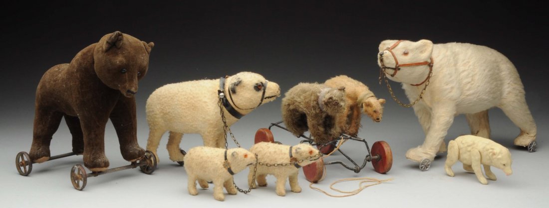Lot Of 5: Bears.: Lot includes: 8” dark brown velveteen Steiff bear with swivel head on cast wheels, no ID, hole in foot pads, circa 1912; mohair over molded body polar bear, non-jointed, muzzle and harness, on wheel
