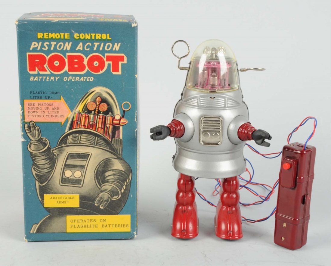 Japanese Piston Action Robby Robot.: Battery - operated. Made in Japan by Nomura. Operated by remote control. Original box does have cardboard inserts, some creasing and edge wear to box. Dome is not scratched or cracked but slightly yel