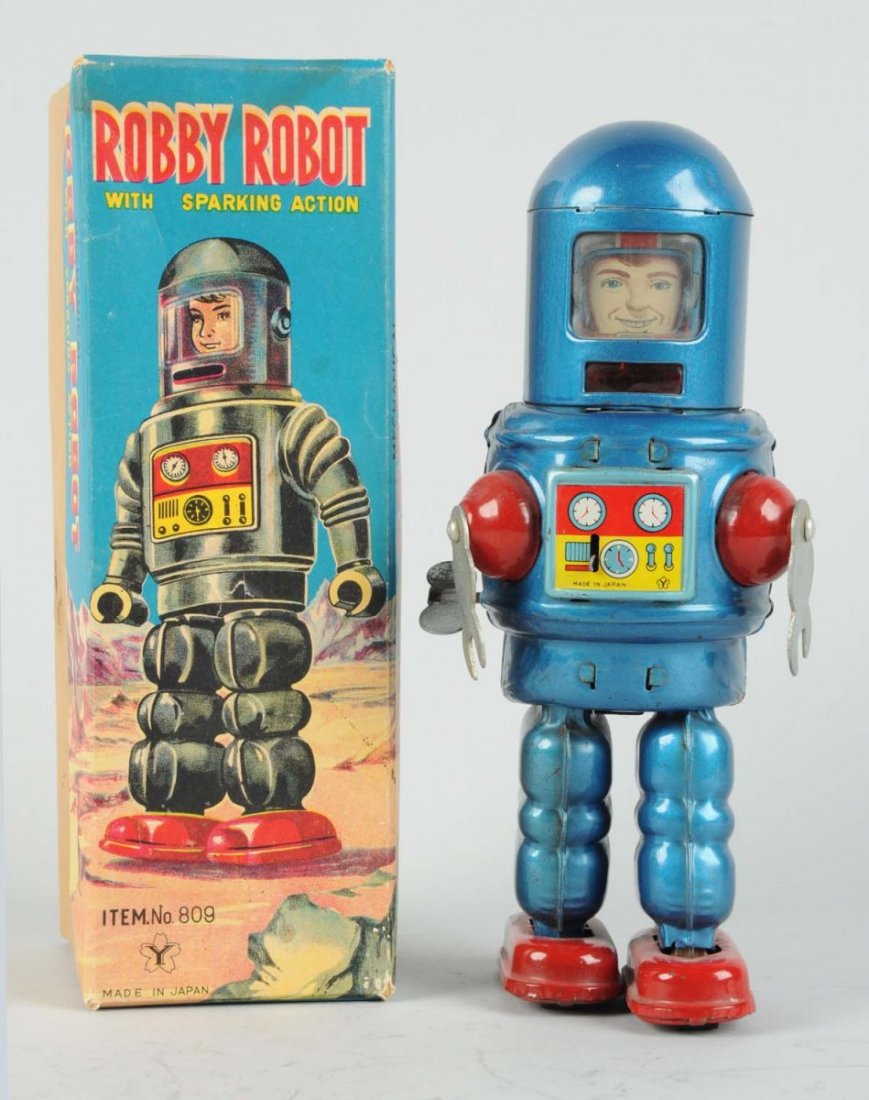 Japanese Tin Litho Robby Robot.: In original box. Made in Japan by Yonezawa. Very scarce box, shows astronaut faced robot. Some minor creasing and edge wear to box. Original plastic face shield in good condition. Some oxidation to ba