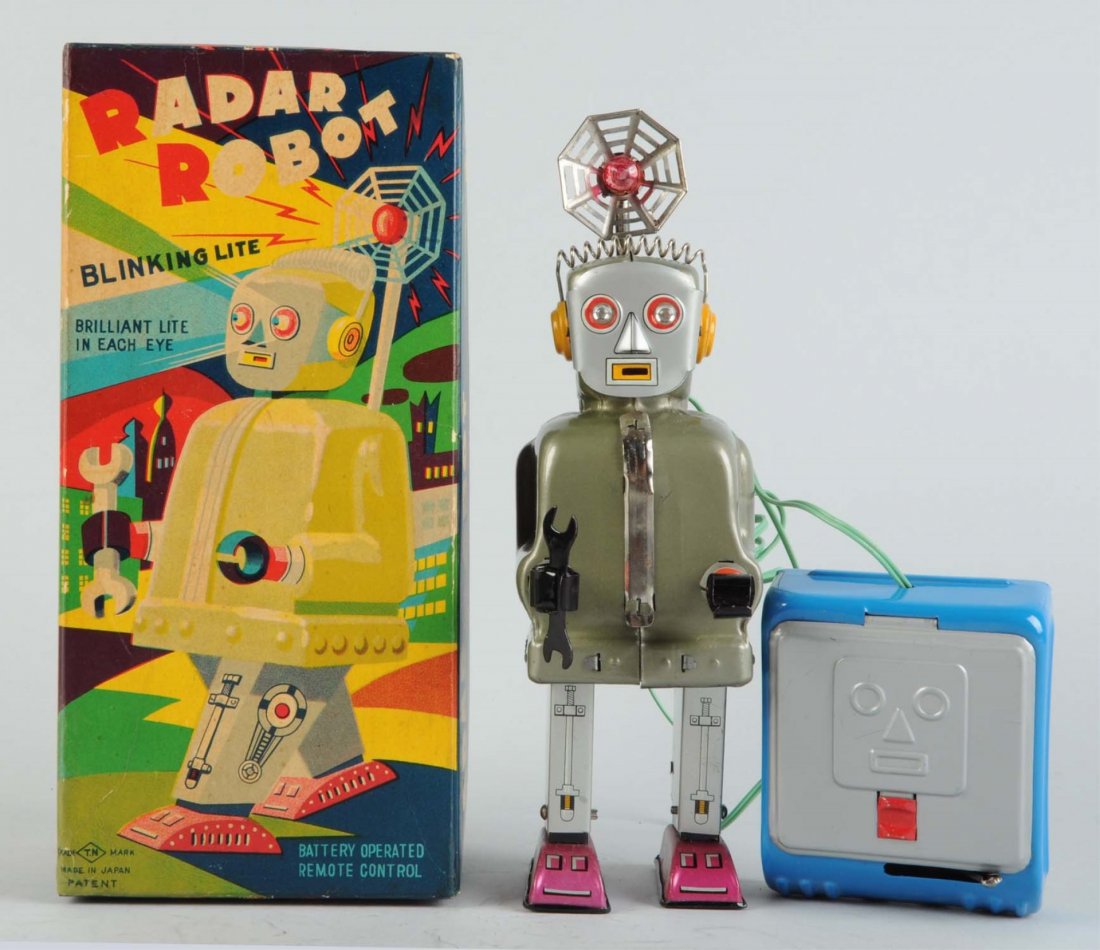 Japanese Battery - Operated Tin Litho Radar Robot: In original box. Made in Japan by Nomura. Has scarce robot face remote. Robot face is embossed into top lid of battery box. Original antenna. Box is fairly crisp but does have some creasing on top and