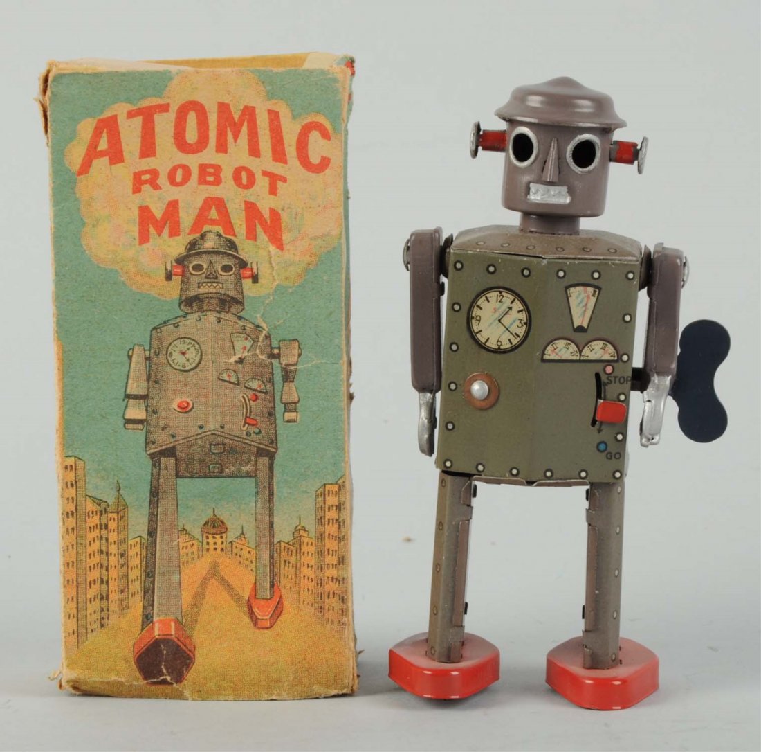 Japanese Tin Litho Atomic Robot Man.: In original box. Wind - Up. Made in Japan. One of the earliest toy robots made. Tin arm version. Box has nice colored graphics. Some creasing and wear, missing end flap and one small inner flap on top