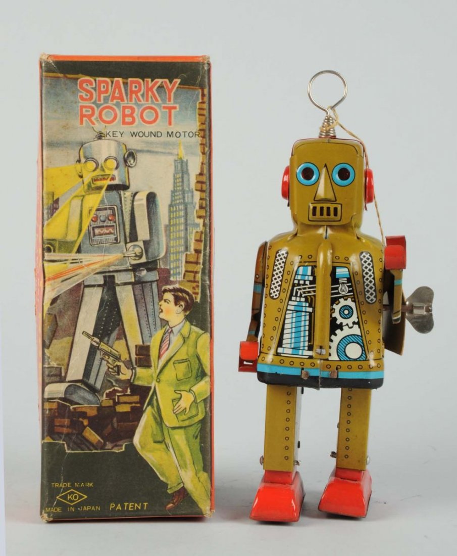 Japanese Tin Litho Wind - Up Sparky Robot.: With original box. Made in Japan by Yoshiya. Very scarce khaki variation. Scarcer "detective" box variation with original operational cardboard tag. Box has some creasing throughout the front of it. R