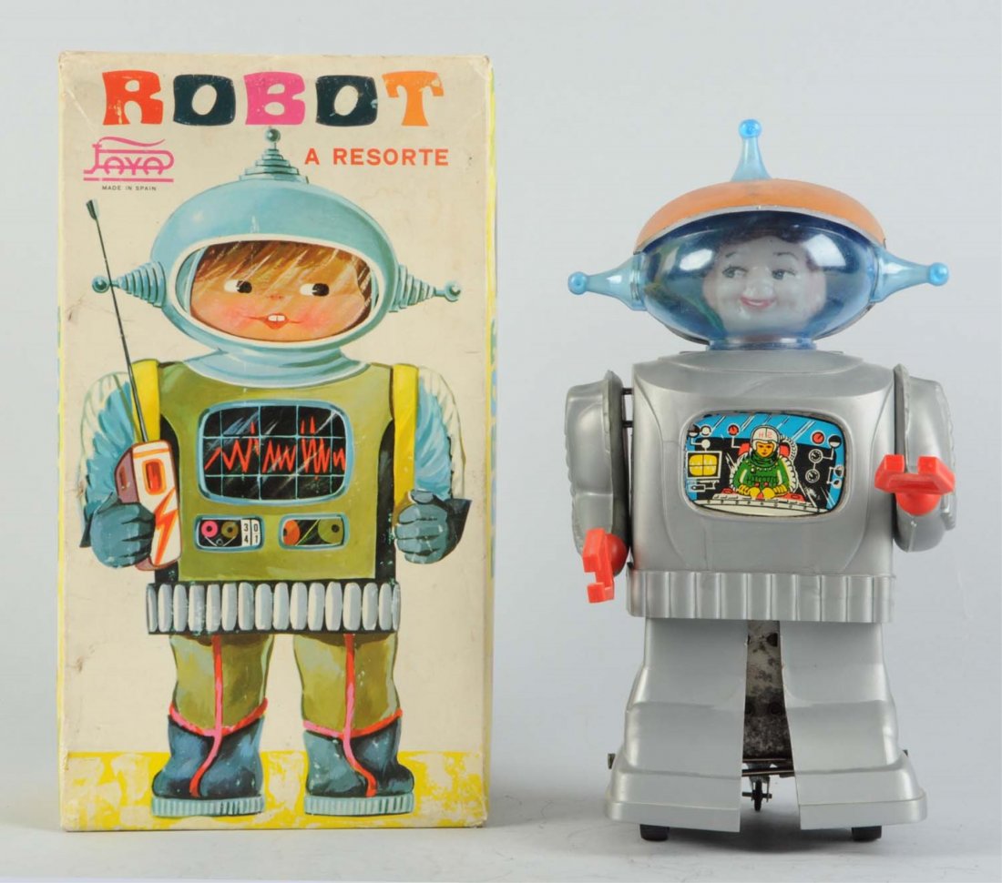 Spanish Battery-Operated Tin Litho & Plastic Robot: In original box. Wind - up. Made in Spain by Joyo. Marked "Paya" on box. Box has some creasing and wear. This is the astronaut face version. Some minor scratching on front of helmet. Condition (Very G