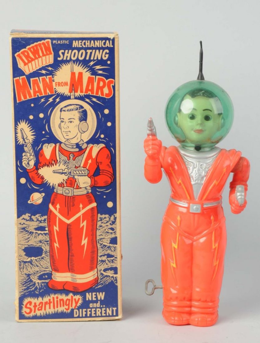Irwin Plastic Man From Mars Robot.: In original box. Wind - up. Made in U.S.A. Original plastic dome and rubber antenna. Marked "Irwin" on back. Arms go up and down. Holding pistols. Red version. Original box has beautiful graphics of s