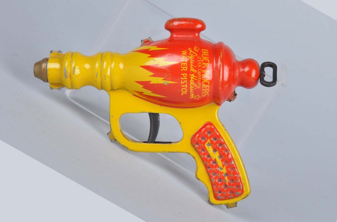 Daisy Buck Rogers Liquid Helium Water Pistol.: Pre-war. Picture of Buck Rogers on one side. Marked "25th Century Liquid Helium Water Pistol - Buck Rogers". Complete and all original. Has some scratching and wear, and initials "P.G." lightly engrav
