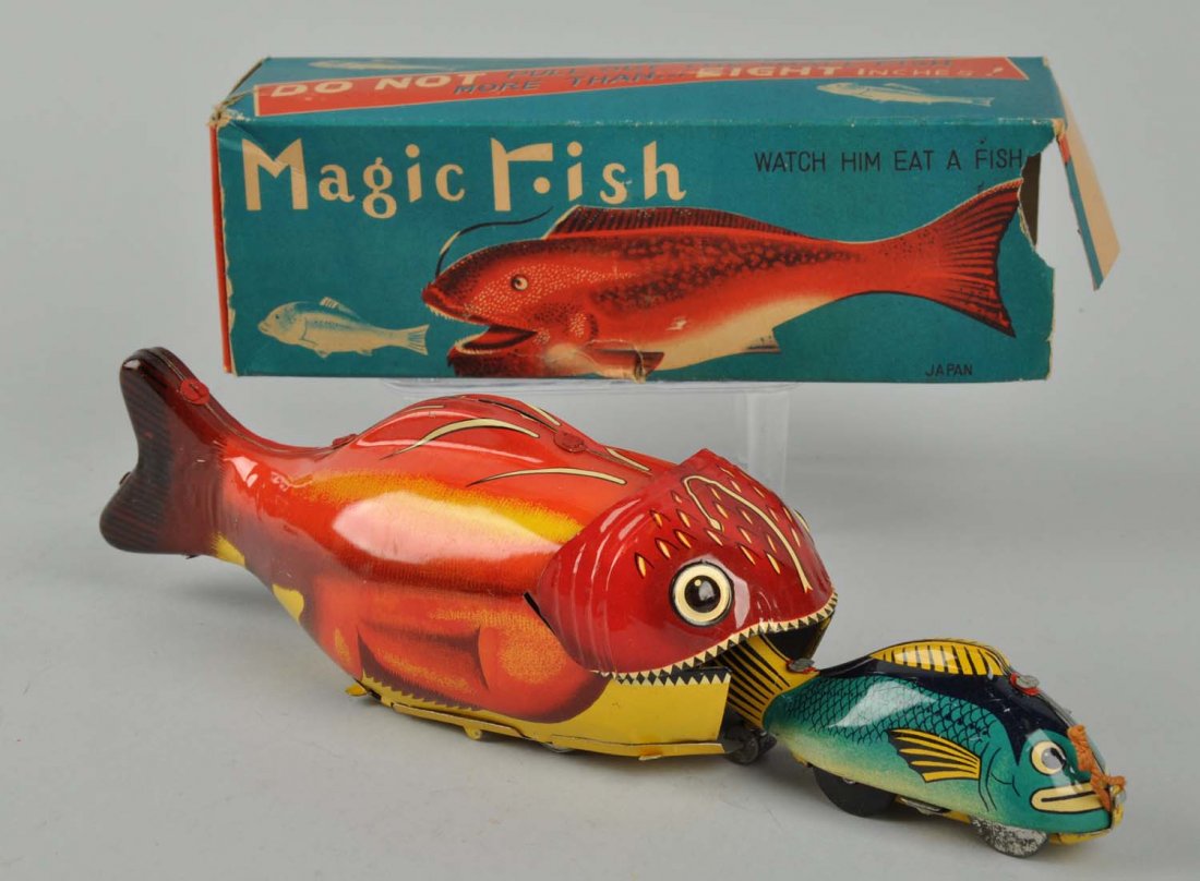 Japanese Tin Litho Friction Magic Fish Toy.: Includes original box. Nice toy where small toy is inside larger fish with teeth, pull out the small fish and he goes back inside the mouth. Nice colorful original box. Missing one end flap. Very litt