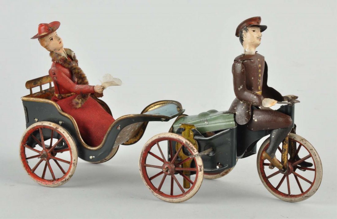 Lehmann's Motor Rad Cycle Mars with Anxious Bride: Circa 1905, Lehmann, Germany; painted tin wind - up. Capped driver steers left and right while frantically peddling. Bride is wearing a cloth dress with a mink stole and carrying a hanky, bounces up a