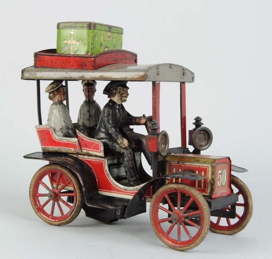 German Tin Litho Clockwork Carette No. 50 Auto.: Closed top version. Appears to be original headlights and all four handpainted driver and passengers. Original rubber tires has some cracking due to age. Some oxidation to metal, scratching and wear. 