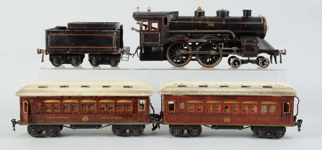 Marklin 1 Gauge Locomotive, Tender & Two Cars.: Locomotive is a 4 - 4 - 0 European outline 1 gauge, complete and all original, has some scratches and paint chips but overall in very good condition. Proper tender for locomotive, is all original, mis