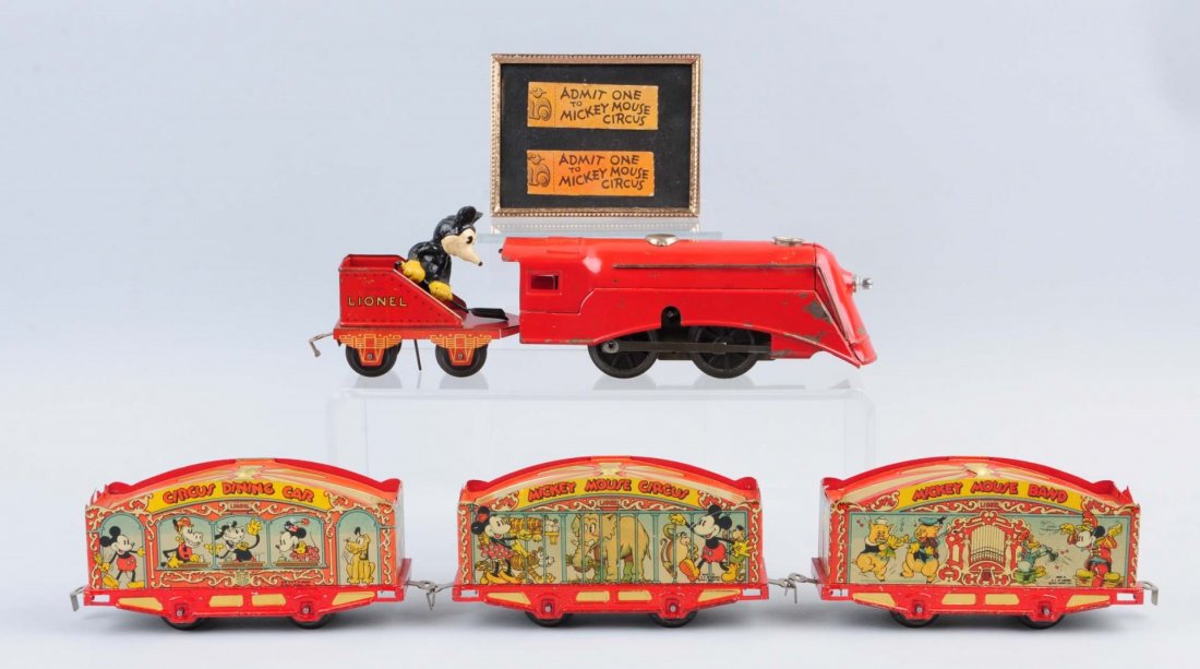 Lionel Walt Disney Mickey Mouse Circus Train Set.: Pre-war. Includes O gauge Lionel Lines clockwork engine, Mickey the Stoker tender, and three tin litho circus cars (Mickey Mouse band car, Mickey Mouse circus car, and a circus dining car). Minor scra