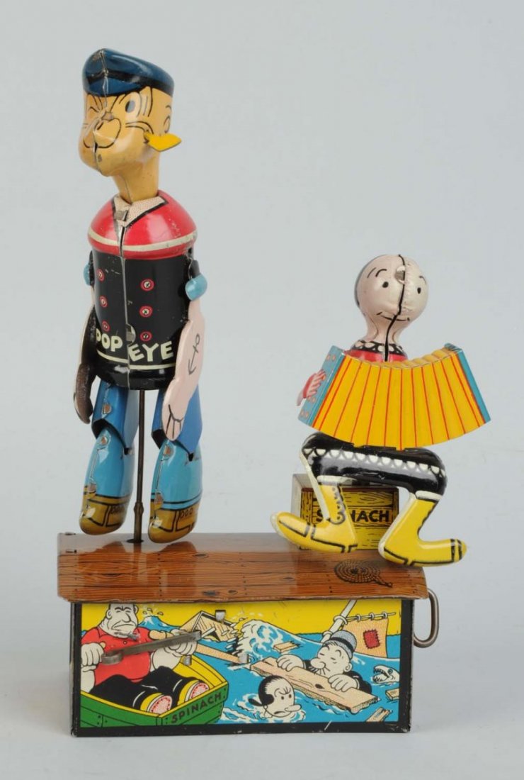 Marx Popeye & Olive Oyl Roof Dancing Toy.: Tin litho wind-up. Olive Oyl has original wire hair bun and Popeye has original pipe. Shiny, glossy litho. Minor scratching and wear beneath Popeye's arms. Condition (Excellent). Size 9" T.