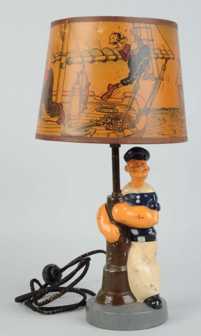 Popeye Pot Metal Lamp With Paper Shade.: White metal base. Looks to be original electric cord. Circa 1935. Marked "Copyright King Features Syndicate". Popeye is missing pipe. Some chipping and wear to figure. Shade is nice but does have some