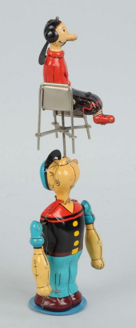 Linemar Popeye Spinning Olive Oyl Toy.: Tin litho wind-up. Olive Oyl has original hair bun and Popeye has original pipe with bowl. Marked "King Features Syndicate" on Popeye's back. When in operation, Popeye hits chair and spins Olive Oyl. 