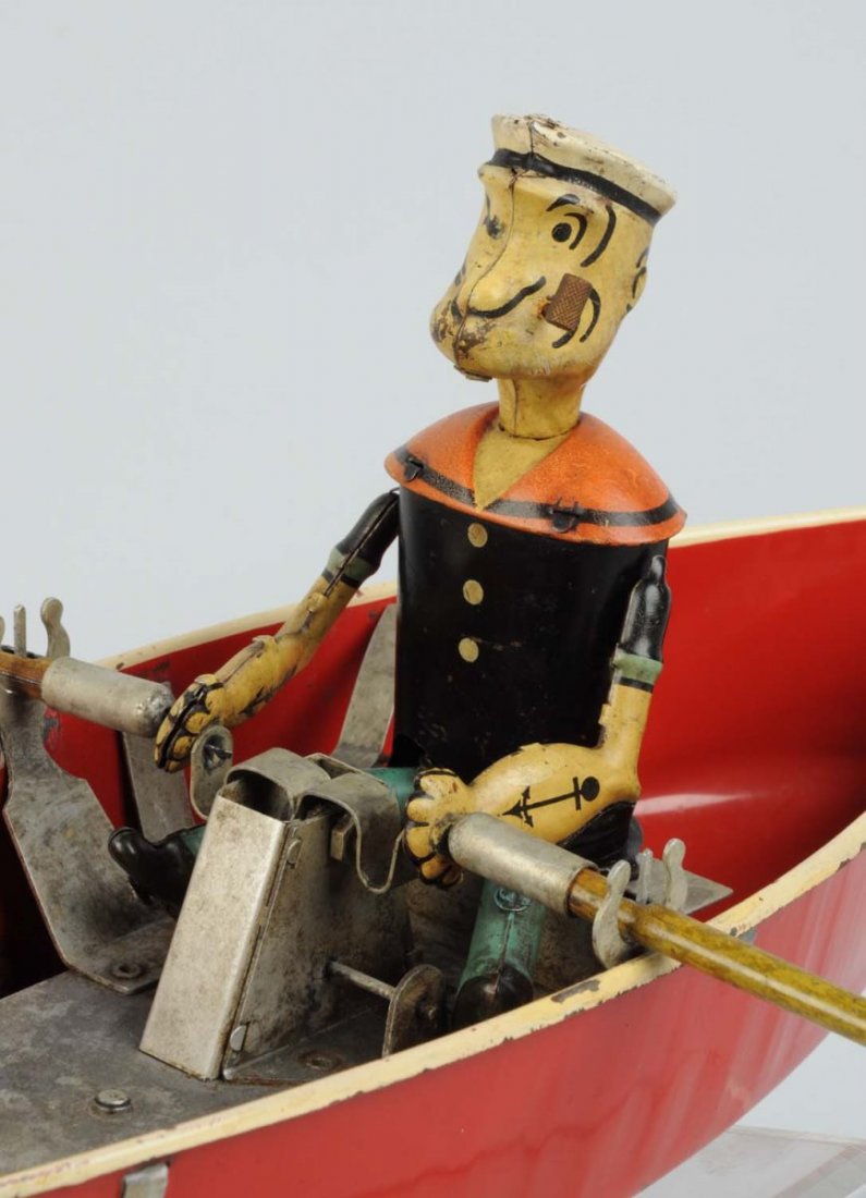 Hoge Pressed Steel Wind-Up Popeye Rowboat Toy.: Copyright 1935 King Features Syndicate. Working. One of the most sought-after Popeye toys. Original oars and pipe. Rudder is a replacement. Decal is very nice, marked "No. 268 Popeye The Sailor". Some