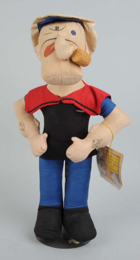 Popeye Cloth Doll With Original Tag.: Made by Effanbee. Cloth doll with original corn cob type pipe. Original clothing. Very slight soiling and very little wear. Original spinach can tag. Copyright 1935 Fleischaker & Baum. Condition (Exce