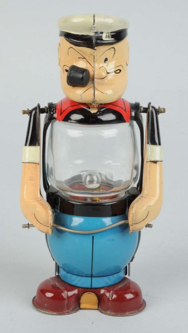 Linemar Popeye Lantern Toy.: Tin litho with original rubber pipe. Battery holder on bottom has been repainted. Works. Condition (Very Good - Excellent). Size 8" T.