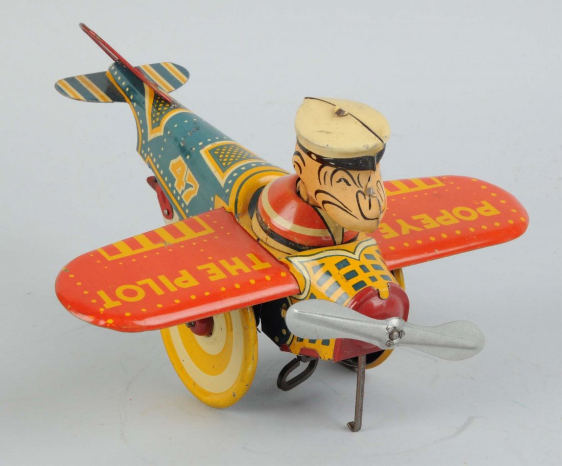 Marx Tin Litho Wind-Up Popeye Airplane Toy.: 1936 version. Original tail fin and propeller. Missing pipe. Minor scratching and wear. Condition (Very Good - Excellent). Size 9 -1/2' L.