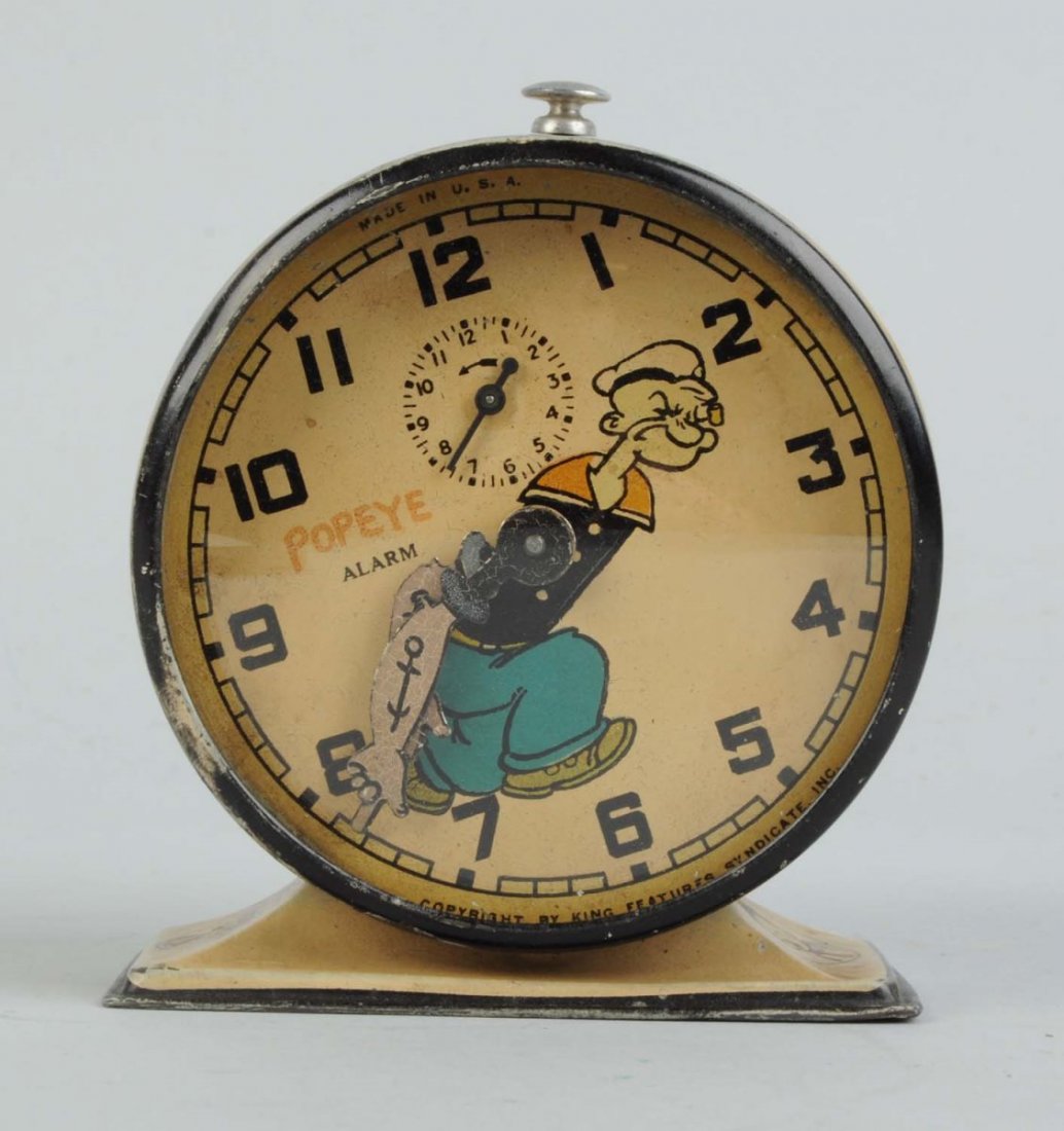 Metal Popeye New Haven Alarm Clock.: Circa 1932. Copyright King Features Syndicate. Working. Lithographed metal case with images of Popeye's Thimble Theater characters. Early Segar signature. Some rubbing and litho loss to top band of cl