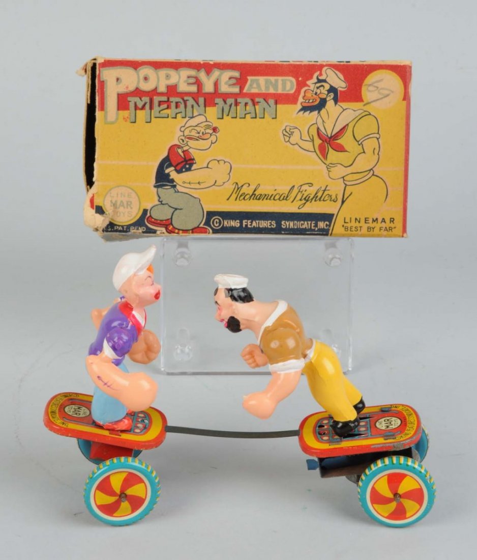 Linemar Popeye & Mean Man Toy.: Tin litho and celluloid wind-up. Includes scarce original box with nice colored graphics. Box is missing one side flap and has slight tear on front lid. Marked "King Features Syndicate". Toy itself ha