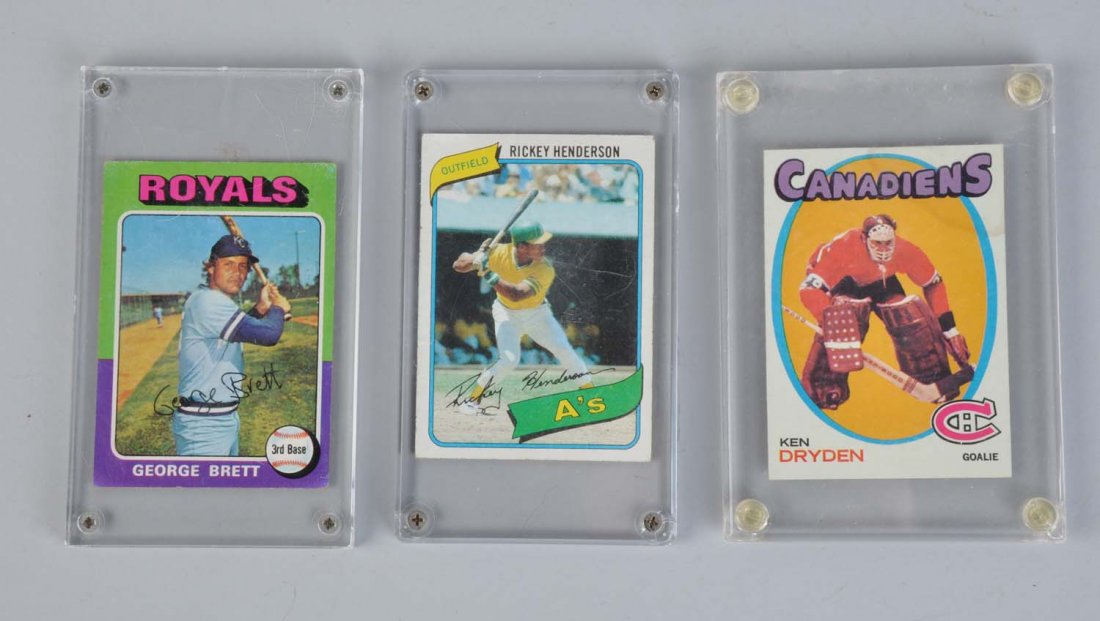 Lot Of 3: Topps Baseball & Hockey Cards.: Includes Topps 1971 - 72 Ken Dryden rookie card No. 445, nice sharp corners, nice centering, 60 - 40 from right to left. Card does have stain in upper right corner. Also 1975 George Brett rookie card 