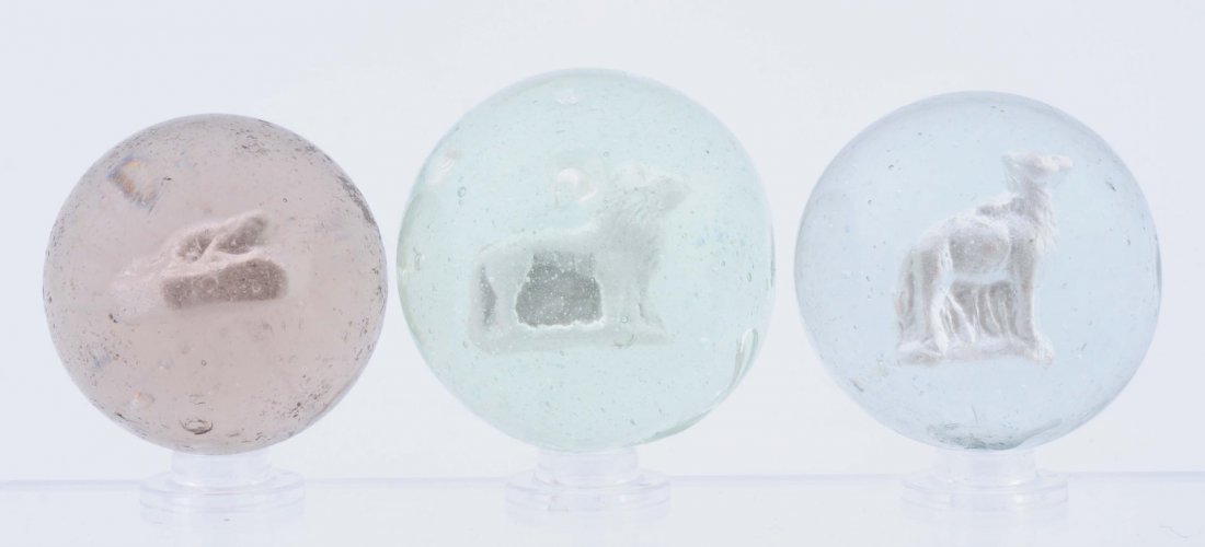 Lot Of 3: Sulphide Marbles.: From smallest to largest: lizard on a rock, standing lion, and a standing dog-like creature. Condition (8.6 - 8.8). Size 1 - 9/16" to 1 - 3/4" Dia.