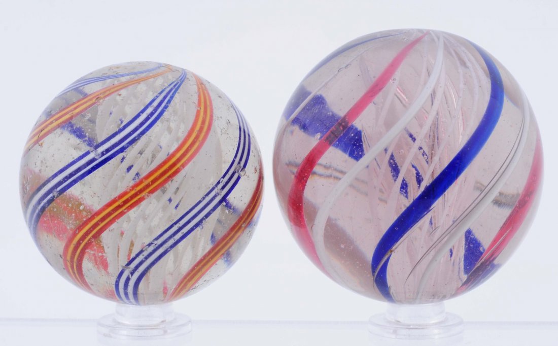 Lot Of 2: Large White Latticino Swirl Marbles.: Lot includes two multicolor white latticino swirl. Both are polished with some damage present. Size 1 - 7/8" - 2 - 1/8" Dia.