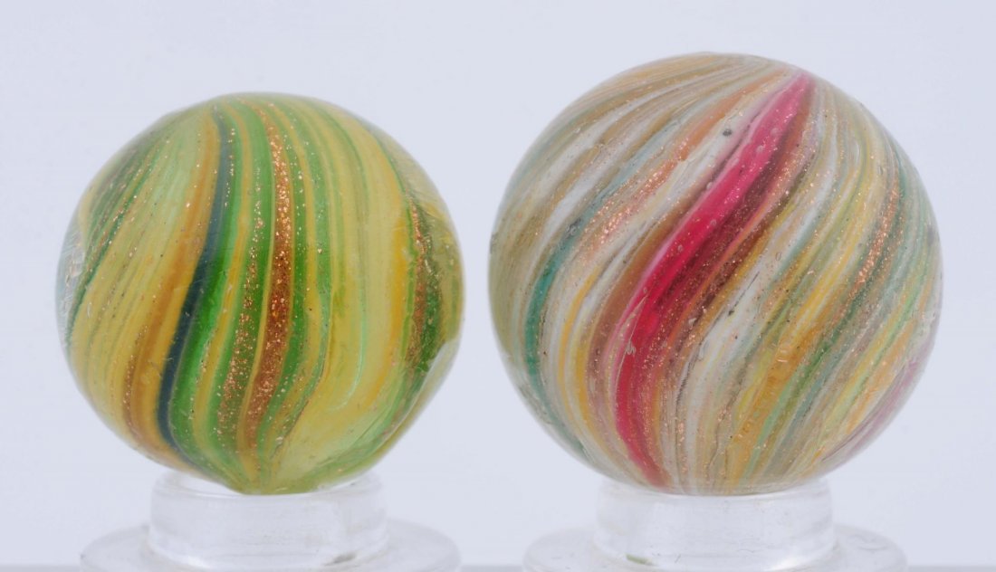 Lot Of 2: Onionskin Lutz Marbles.: The smaller is yellow and green with Lutz and the larger is pink, white, yellow, and green with Lutz. Condition (8.8 - 9.0). Size 25/32" to 7/8" Dia.