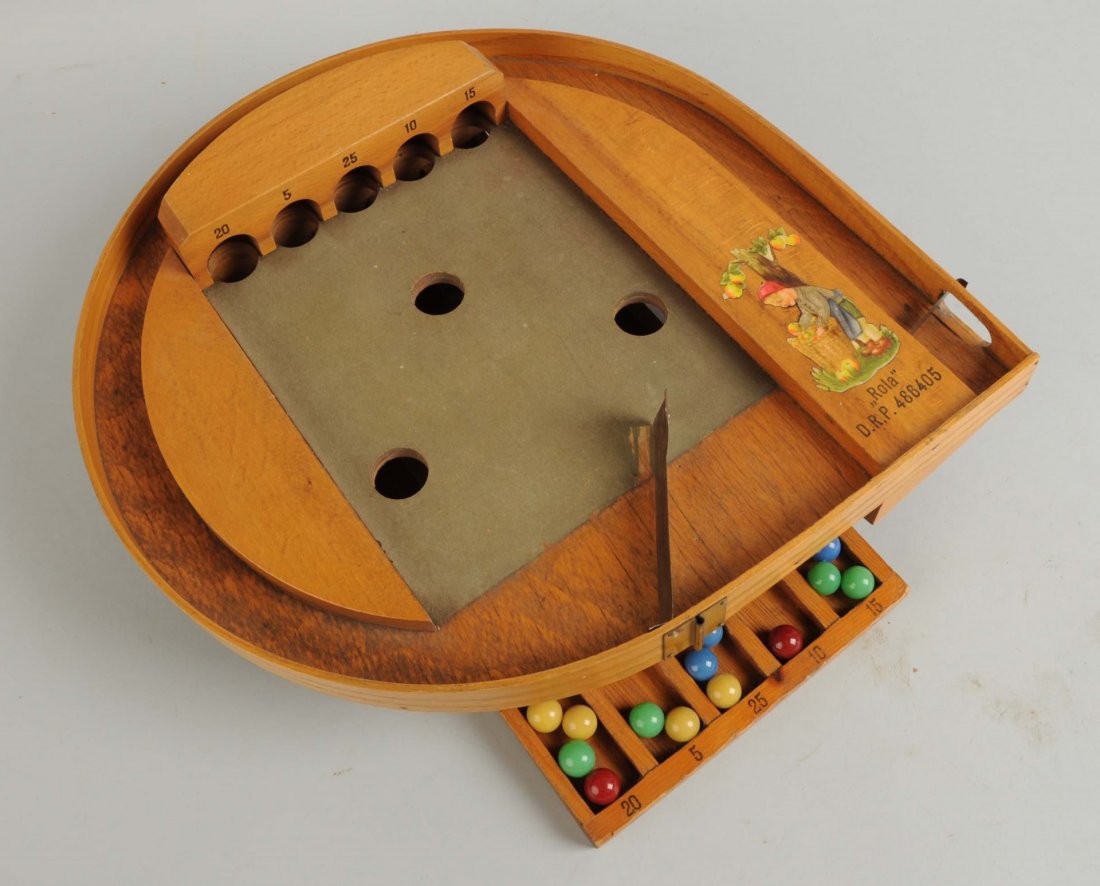 Rola Marble Game.: This is a very unusual old German marble game using a spring like metal strip on the right side to shoot the marbles along a wooden ramp into the center of the game which is covered with a felt like m