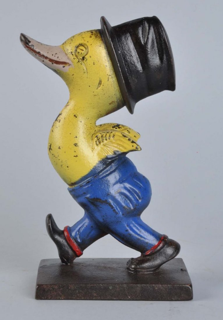 Cast Iron Walking Duck In Top Hat Doorstop.: Delightful caricature of whimsical duck walking, wearing top hat done in deco colors. Full-figure, solid casting. Condition (Excellent). Size 7 - 3/4" T.
