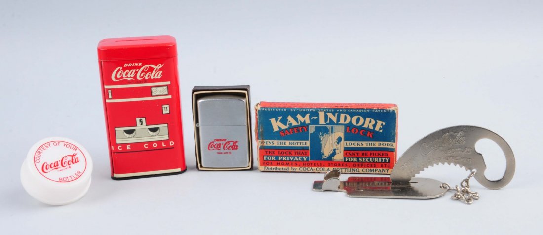 Lot Of 4: Coca - Cola Items.: Lot includes a night light, lighter, coin bank and safety lock. Little to no wear on all items. 1930s - 1970s. Condition (Near Mint). Size Largest : 4" L.
