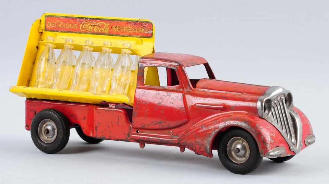 Early Pressed Steel Metalcraft Coca - Cola Truck.: Moderate wear and scratches throughout. Labels are not original and it is missing the head lights. Does have all 10 Coca-Cola bottles. Condition (Good). Size 12 -1/2" L.