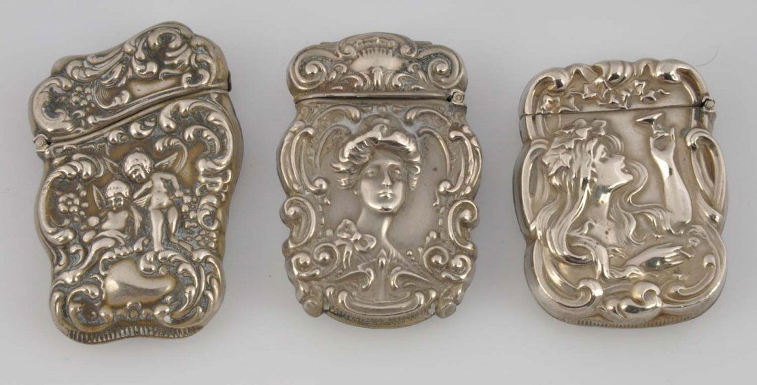 Lot Of 3: Sterline Match Safes Or Vestas.: All by James Blake Co. All three embossed. Two with Art Nouveau ladies and one with angels. Minor wear. Condition (Excellent). Size Each : 2 -1/2" T.