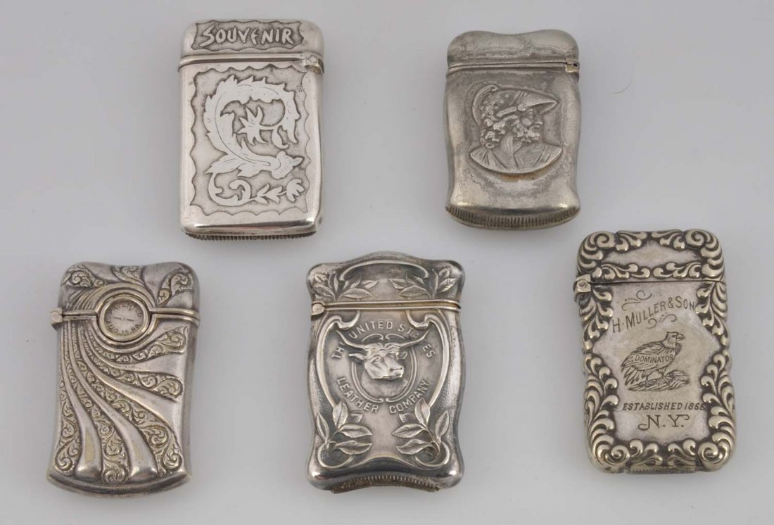 Lot Of 5: German Silver Match Safes Or Vestas.: The first one is a U.S leather co with steer, the second is two men and helmet, the third is with a cigar cutter, the forth is H. Moller & Son and the fifth is Souvenir. Minor wear. Condition (Excelle
