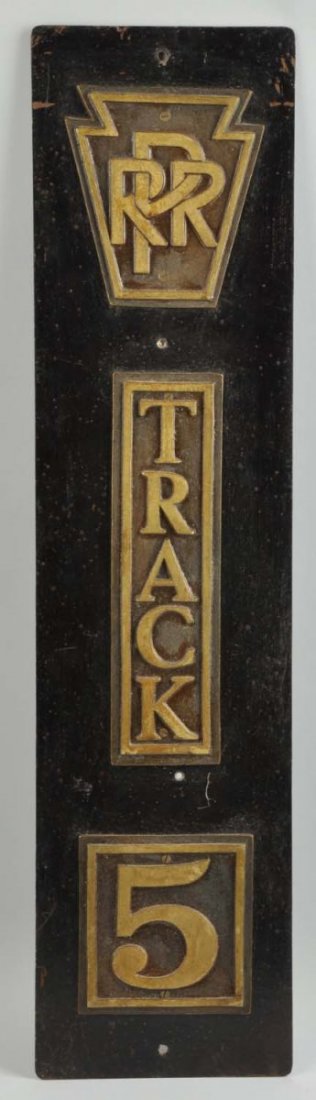 Pressed Steel & Cast Iron Vintage Railroad Sign.: Vertical type sign with keystone on top with "PRR" for Pennsylvania Railroad inside keystone. Also in the middle is embossed "track 5". Pressed steel backing with cast iron emblems. Some scratching, p